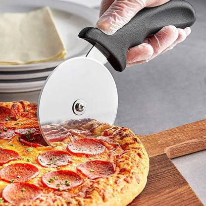 Pizza cutter cutting pizza on wooden board